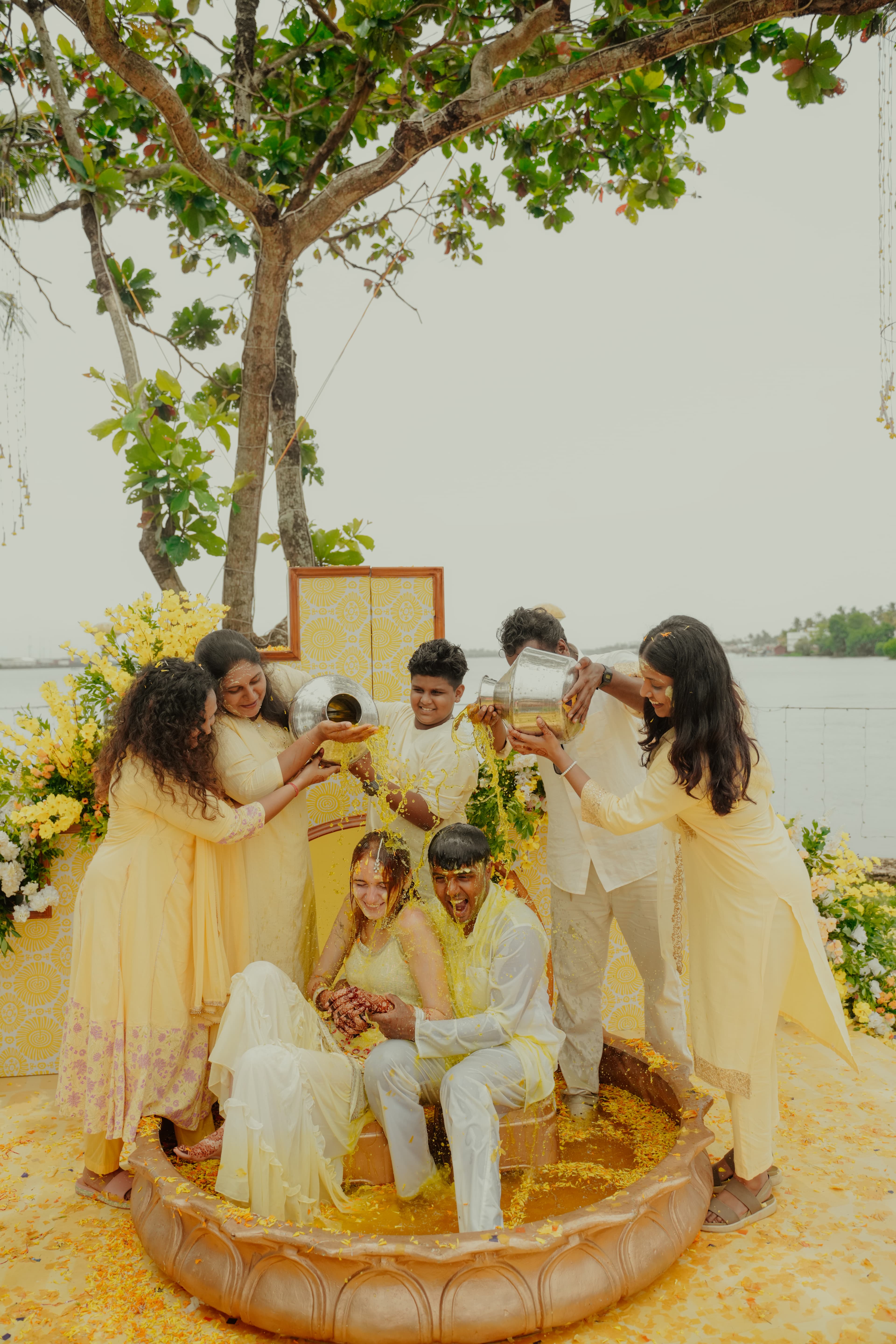 Candid moment from a vibrant Indian wedding Haldi ceremony in Kerala